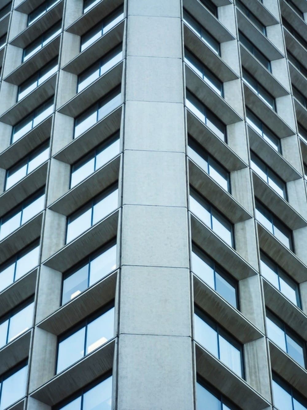 Facade of an office building with a regular grid of windows.